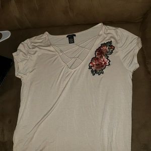 An off white tee with rose design